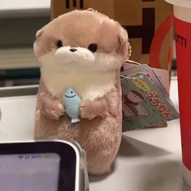 Baby Otter Plushie Holding a Fish Pendant