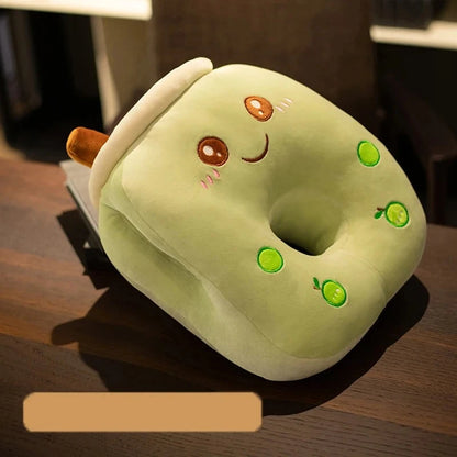 A smiling green pillow with a hole in the middle, two small green apples, and two small round circles representing apple boba.