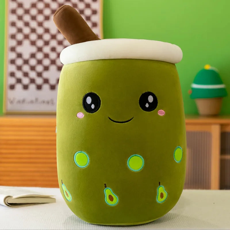 Product image showing a green avocado bubble tea with small avocado icons, two black eyes, a smile, and a brown straw at the top