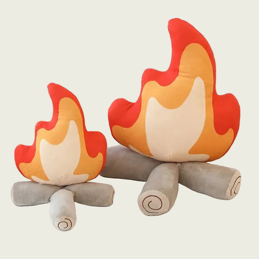 Two bonfire flame with logs plushies on a white couch with a neutral background