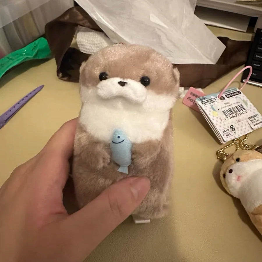 Baby Otter Plushie Holding a Fish Pendant