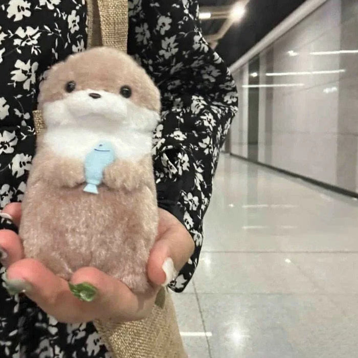 Baby Otter Plushie Holding a Fish Pendant
