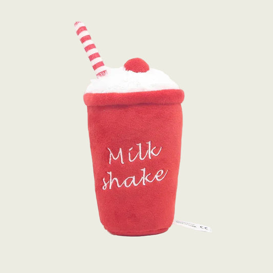 Red plush toy resembling a milkshake with a straw on a white background