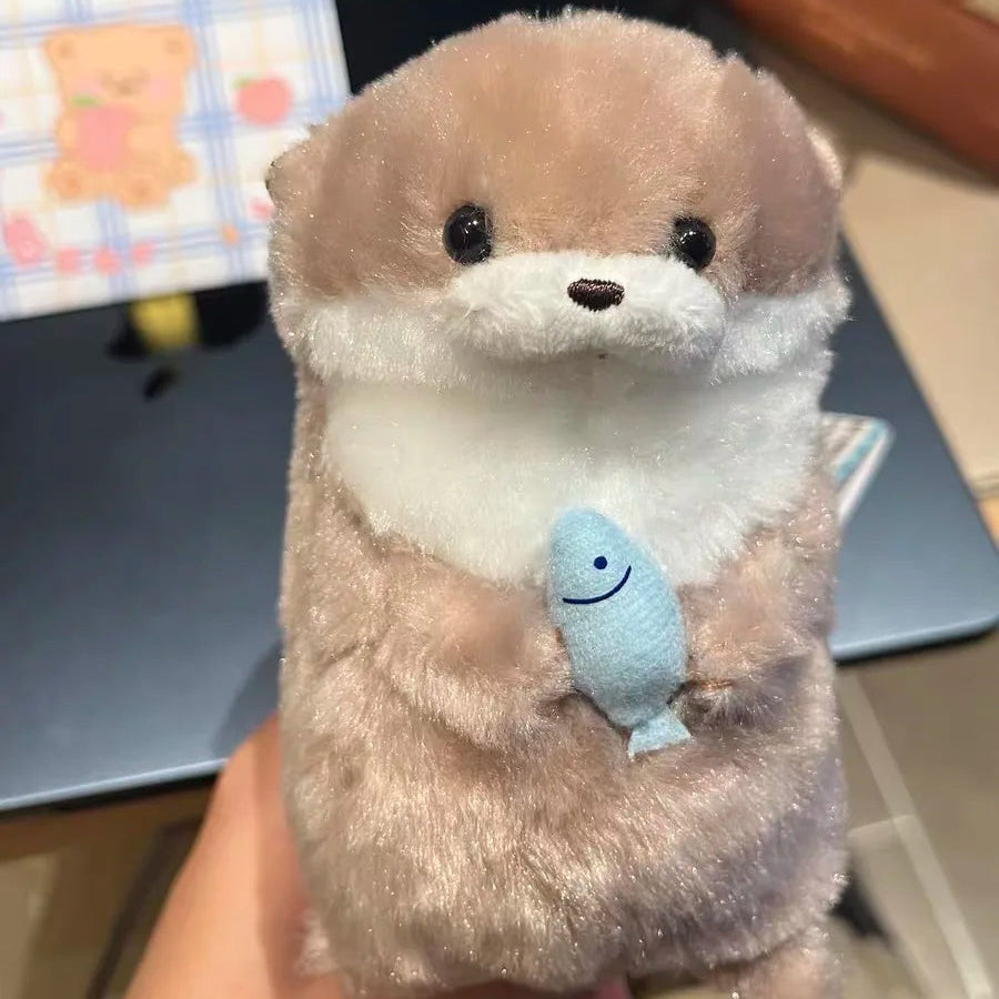 Baby Otter Plushie Holding a Fish Pendant
