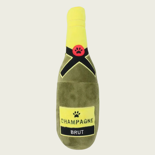 Dog toy shaped like a champagne bottle with a paw print design on a beige background