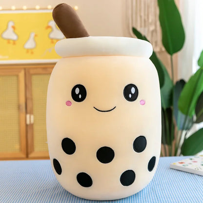 Product image of a brown sugar bubble tea beverage with wide open black eyes, a cute smile, black balls representing tapioca, and a brown straw out the top