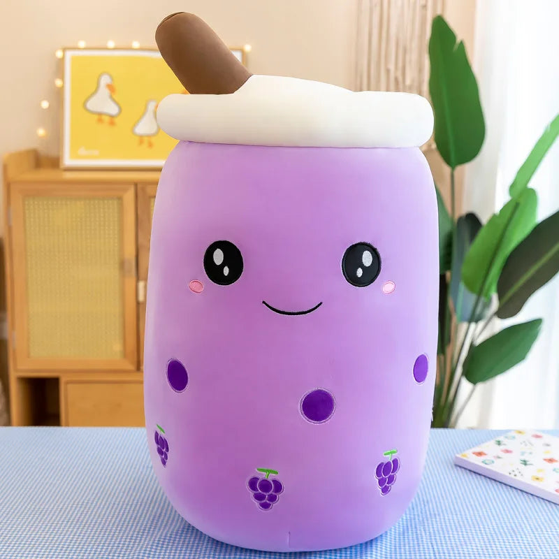 Product photo of a purple boba tea with a smiling face, grape icons, and a brown straw at top with white foam