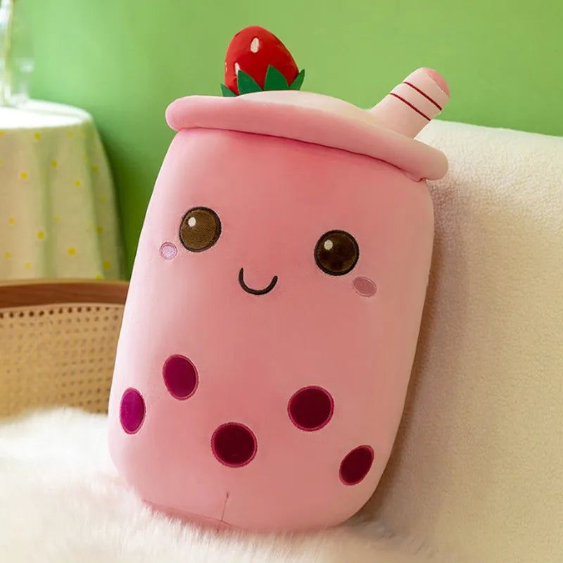 Image of a pink boba tea plushie with five purple-magenta boba tapiocas, an upside-down strawberry at the top, and a pink straw