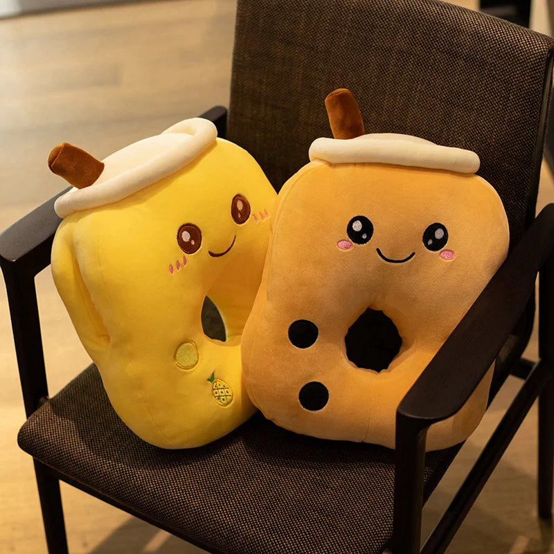 The image shows two bubble tea middle-hole pillows (a yellow pineapple and brown sugar) on a basic office chair.